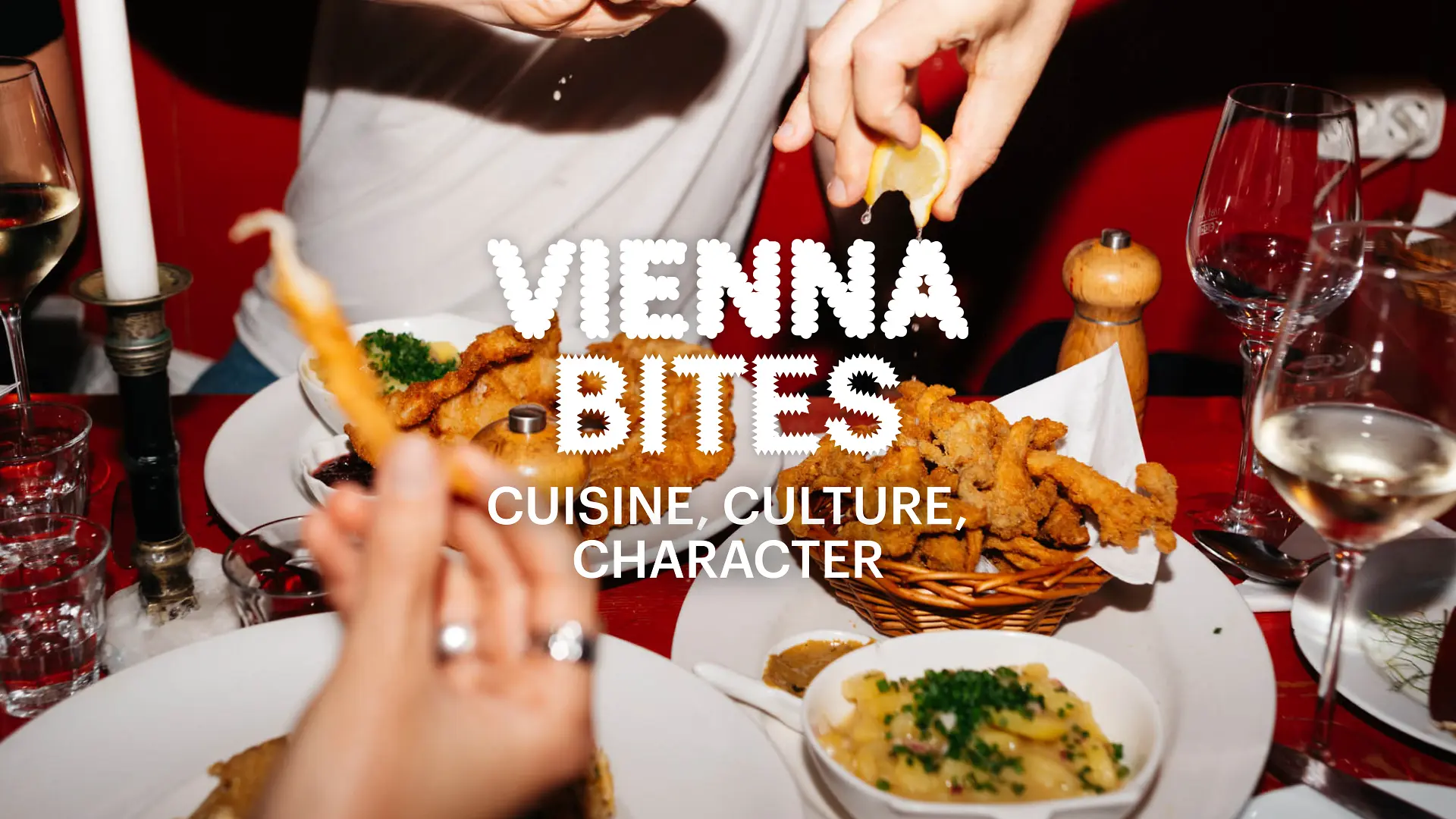 Slogan “Vienna Bites. Cuisine, Culture, Character” in the background Food on a table
