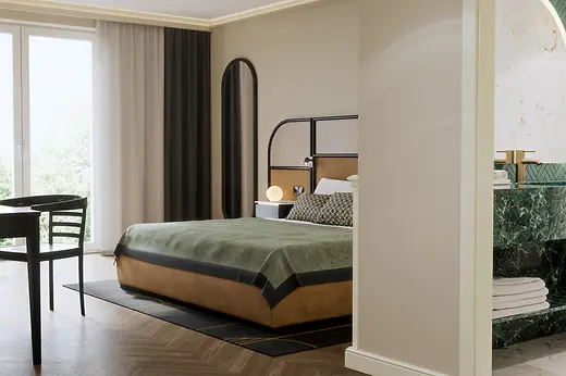 A stylish hotel room with a modern bed in green and beige tones, complemented by a tall curved mirror and floor-to-ceiling curtains, with a glimpse into a luxurious marble bathroom featuring green stone surfaces.