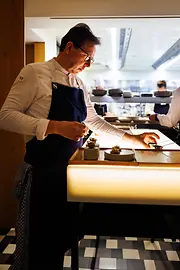 Star chef Heinz Reitbauer plating dishes at the Steirereck restaurant