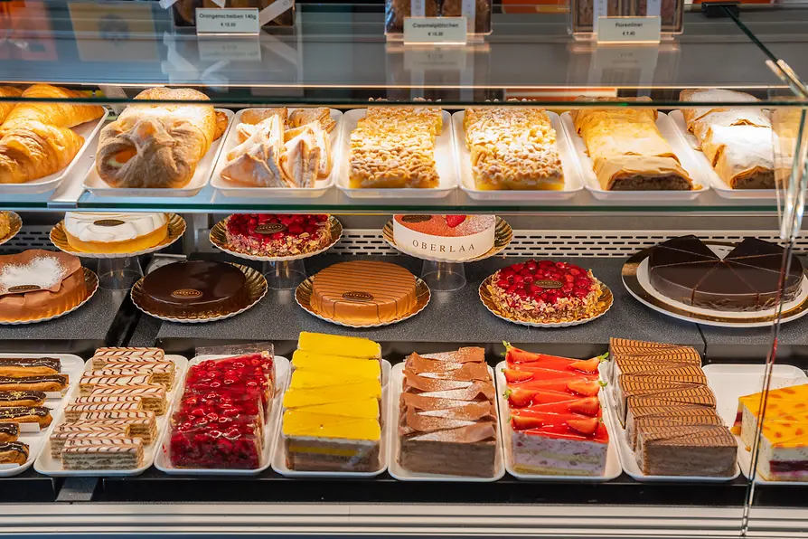 Selection of cakes, pastries and baked goods in the Café Dommayer display case.