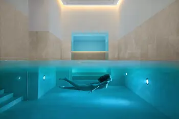 Indoor pool at Almanac Palais Vienna with a swimmer.