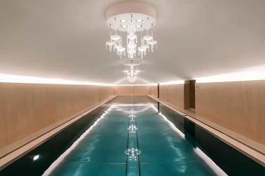 Indoor pool at Sans Souci Spa with crystal chandeliers and illuminated water.