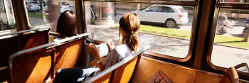 Two women are riding in a tram on Vienna's Ringstrasse boulevard