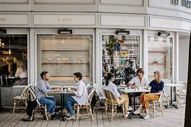 People sitting in the open air outside a café