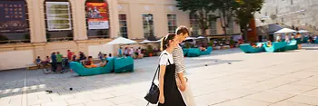 A couple walks in the inner courtyard of the Museumsquartier