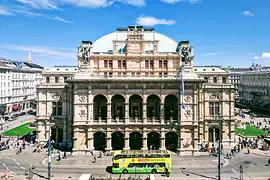 Yellow Hop-On Hop-Off bus of Vienna Sightseeing Tours in front of the State Opera