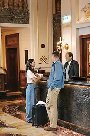 Hotel reception: Guests and receptionist