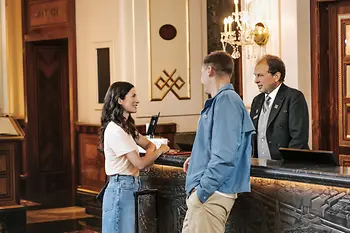 Hotel reception: Guests and receptionist