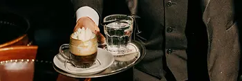 Café Schwarzenberg, waiter serves an "Einspänner" (coffee)