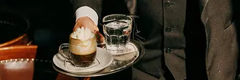 Café Schwarzenberg, waiter serves an "Einspänner" (coffee)