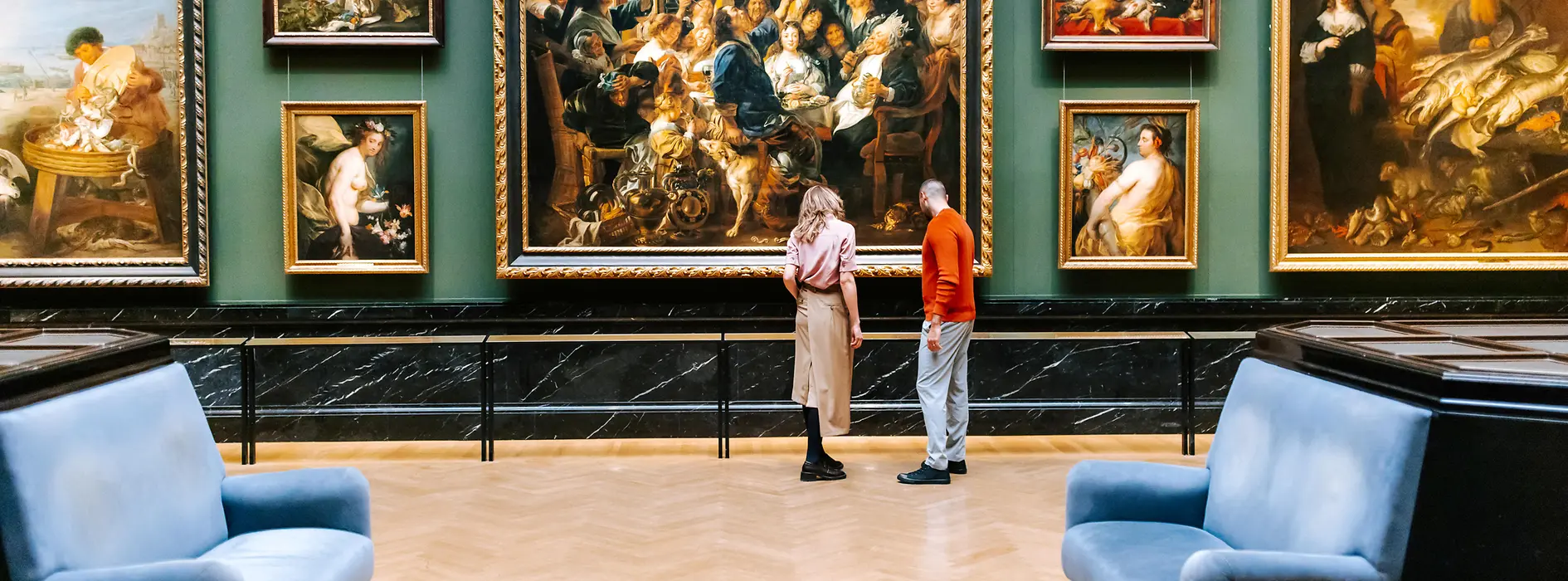 Kunsthistorisches Museum in Vienna. A man and a woman look at paintings from the Baroque period.