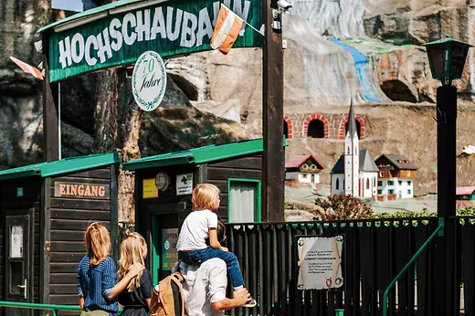 Vienna Prater, family in front of the rollercoaster \"Hochschaubahn\"