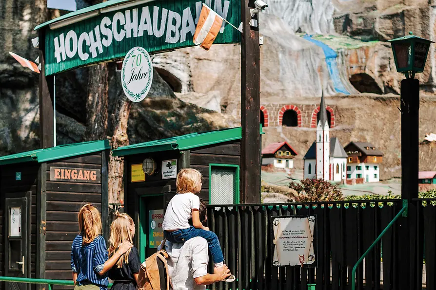 Vienna Prater, family in front of the rollercoaster \"Hochschaubahn\"