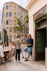 People in front of the entrance to a bar