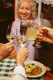 A group raising a toast with wine and grape juice