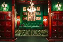 Hotel Sacher, green bench, green wall, pictures on the wall