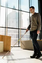 Blind person uses tactile guidance system on the floor. 